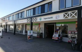 SPAR Cadzand-Bad supermarkt in een modern winkelpand met fietsen en kinderattractie bij de ingang.